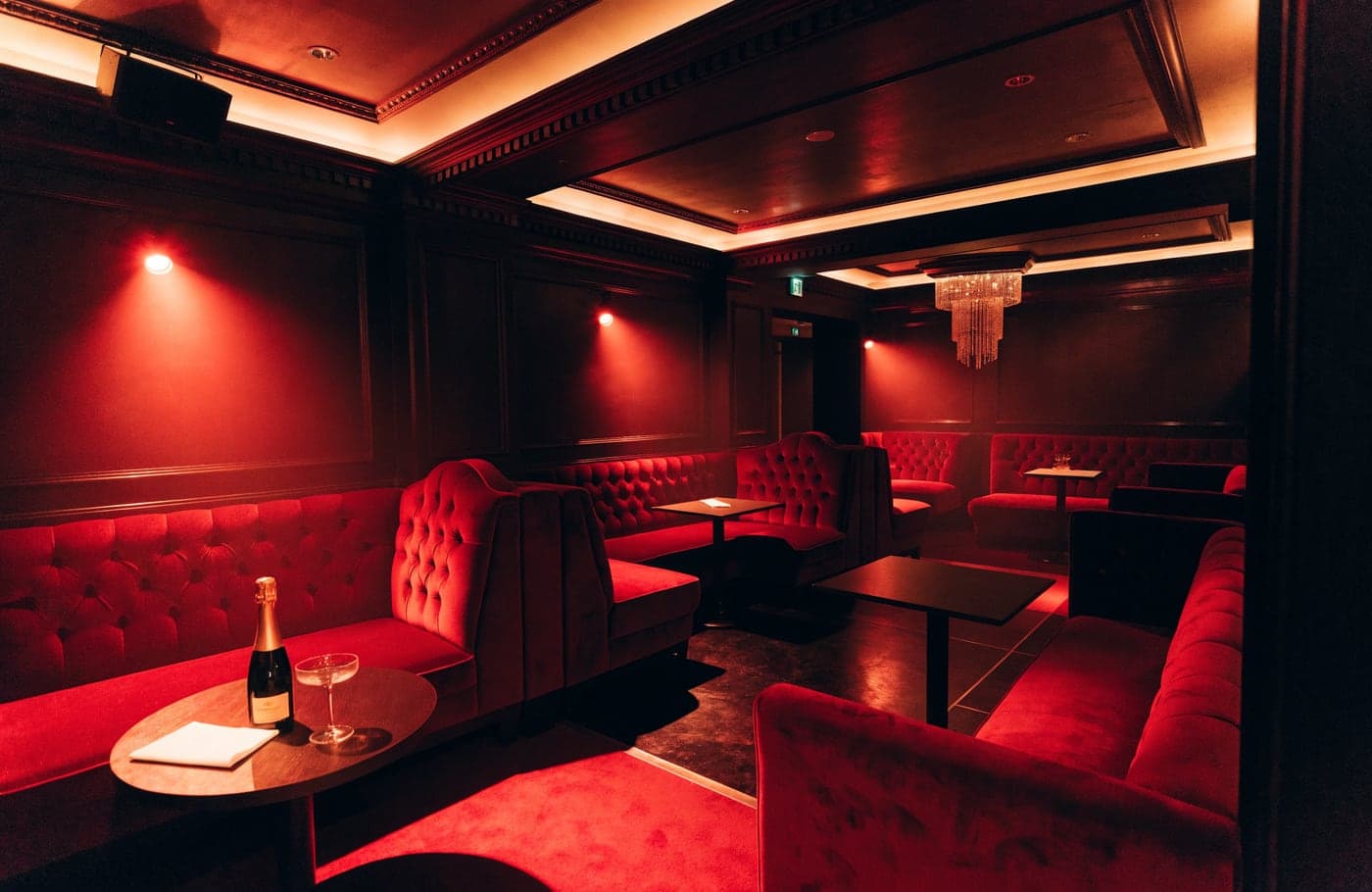 The red velvet booths in the main room at Rumour